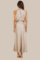 Elegant Carola - Halter Neck Satin Dress featuring a modern design and subtle shine, perfect for any occasion.